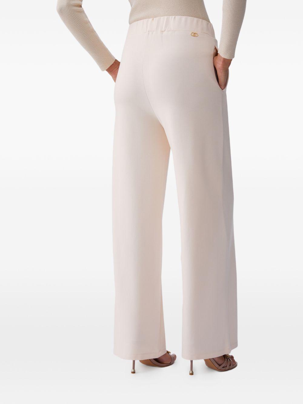 LIUJO Pantaloni cremai in jersey con dettaglio catena