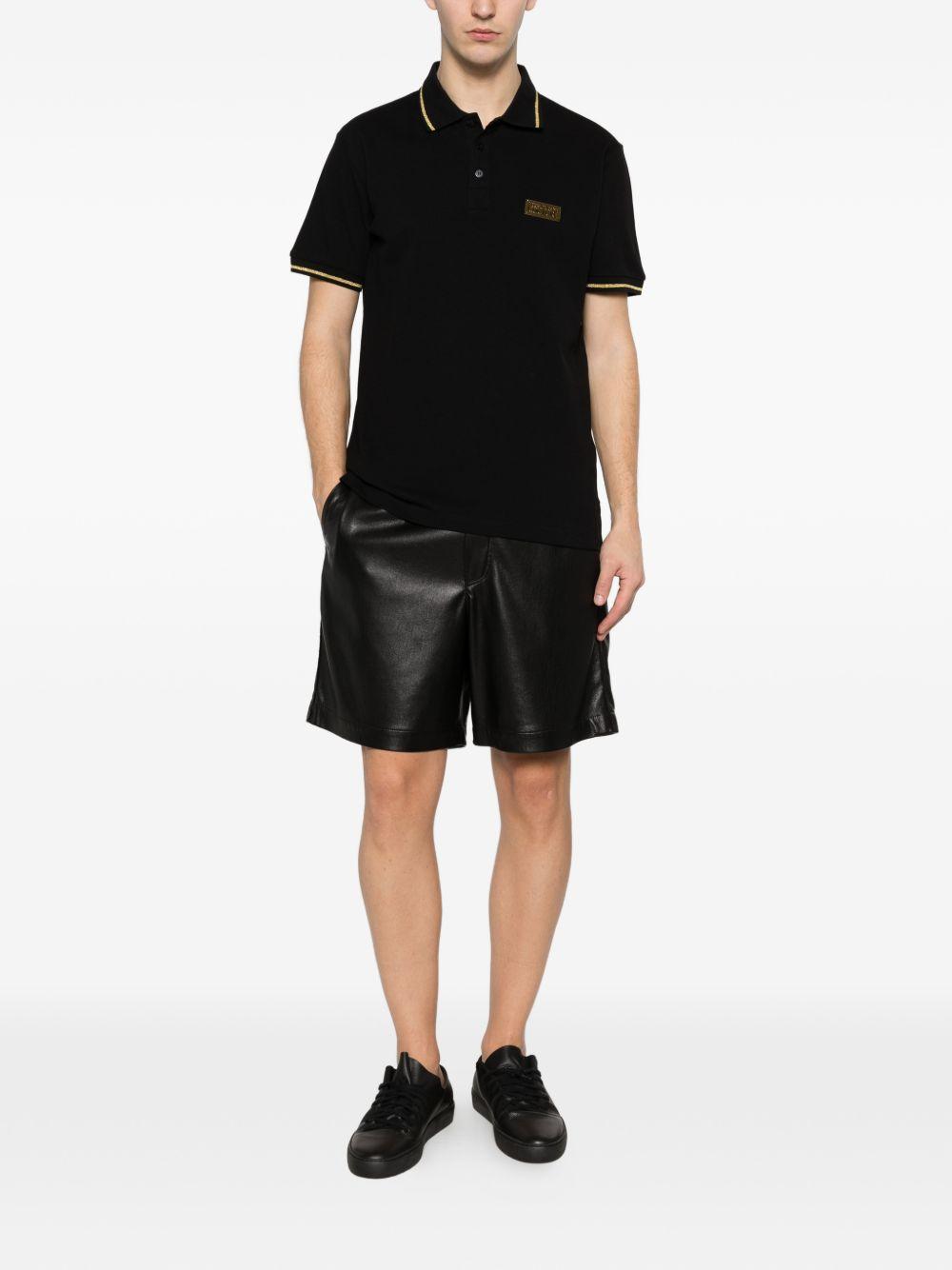 VERSACE JEANS COUTURE Polo nera con bordo a coste e logo