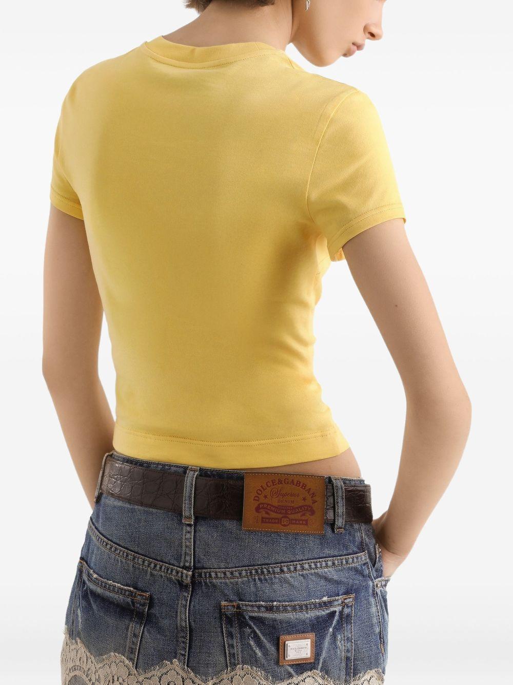 DOLCE e GABBANA Mini gonna in denim con pizzo bianco