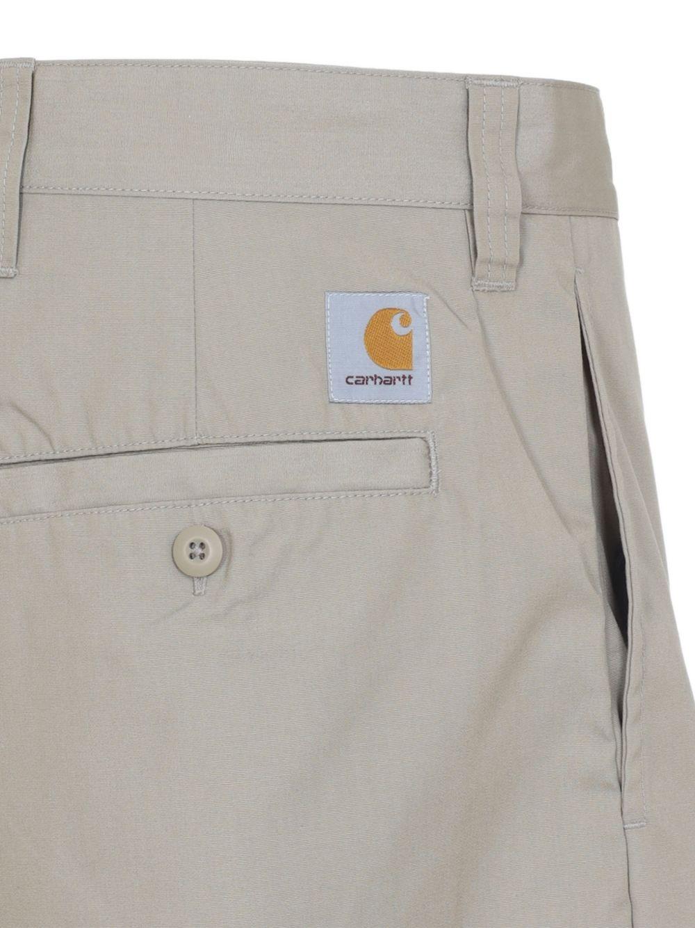 CARHARTT WIP Pantaloni svasati in cotone beige con logo