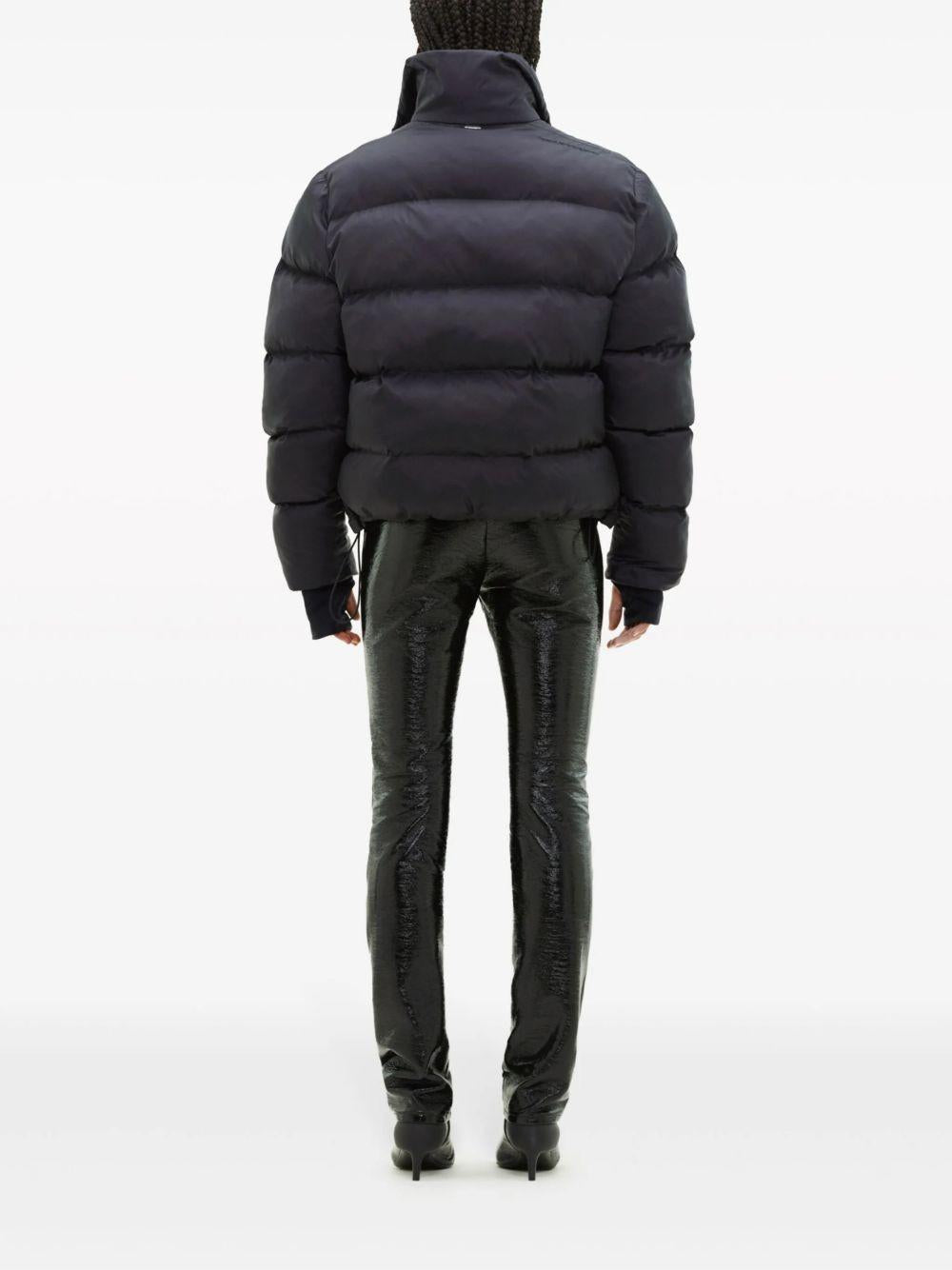 COURREGES Piumino nero con coulisse in vita e tasche laterali