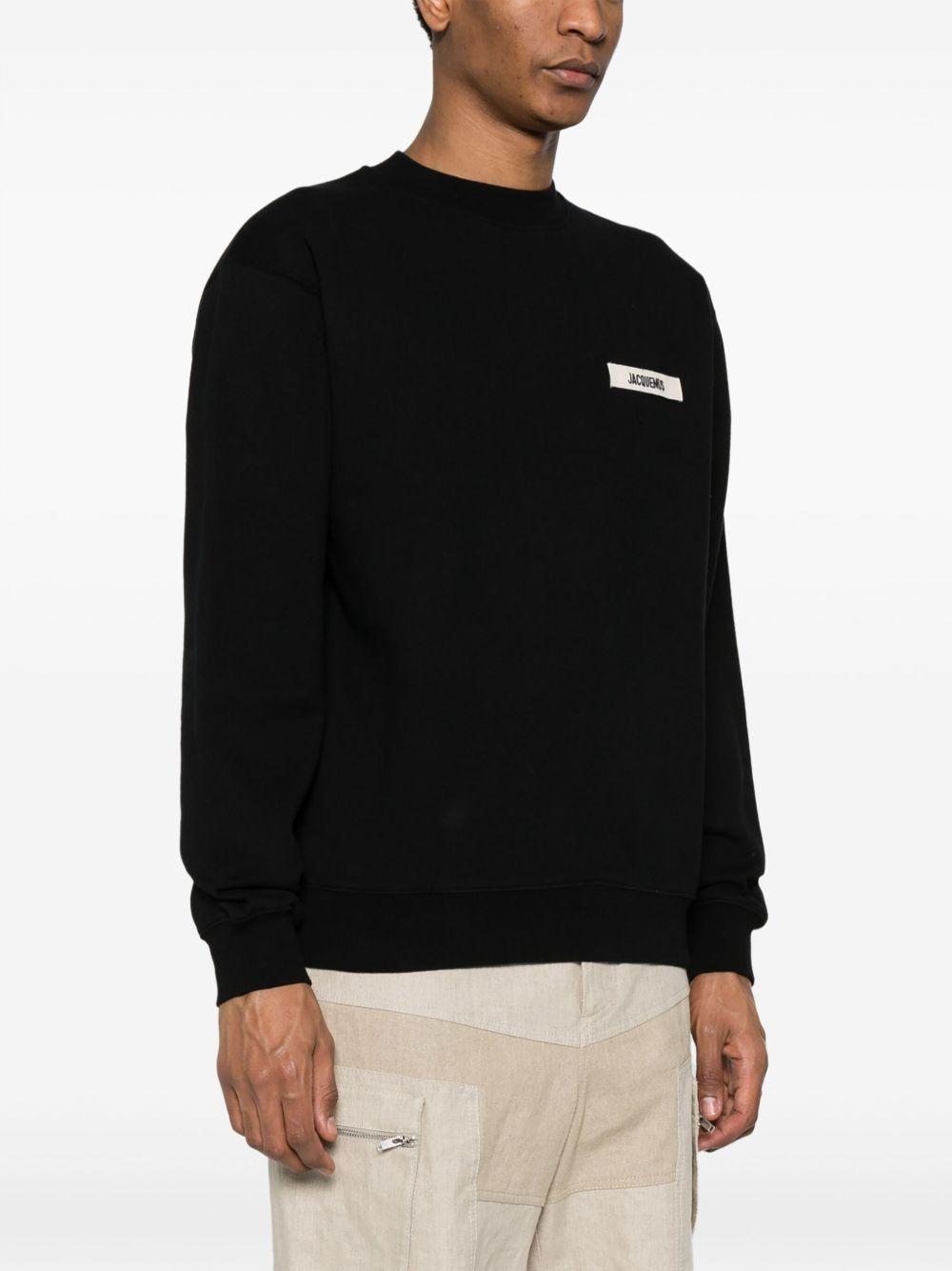 JACQUEMUS Felpa nera in cotone con patch logo sul petto