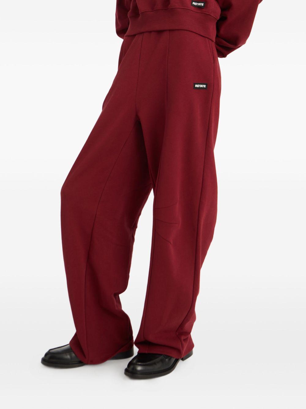 ROTATE Pantaloni sportivi tuta burgundy