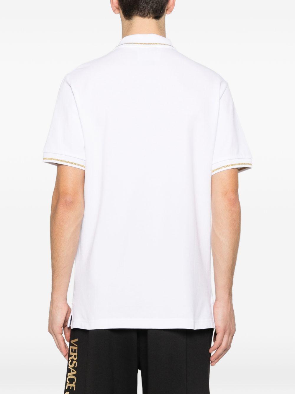 VERSACE JEANS COUTURE Polo in cotone bianco con logo oro 