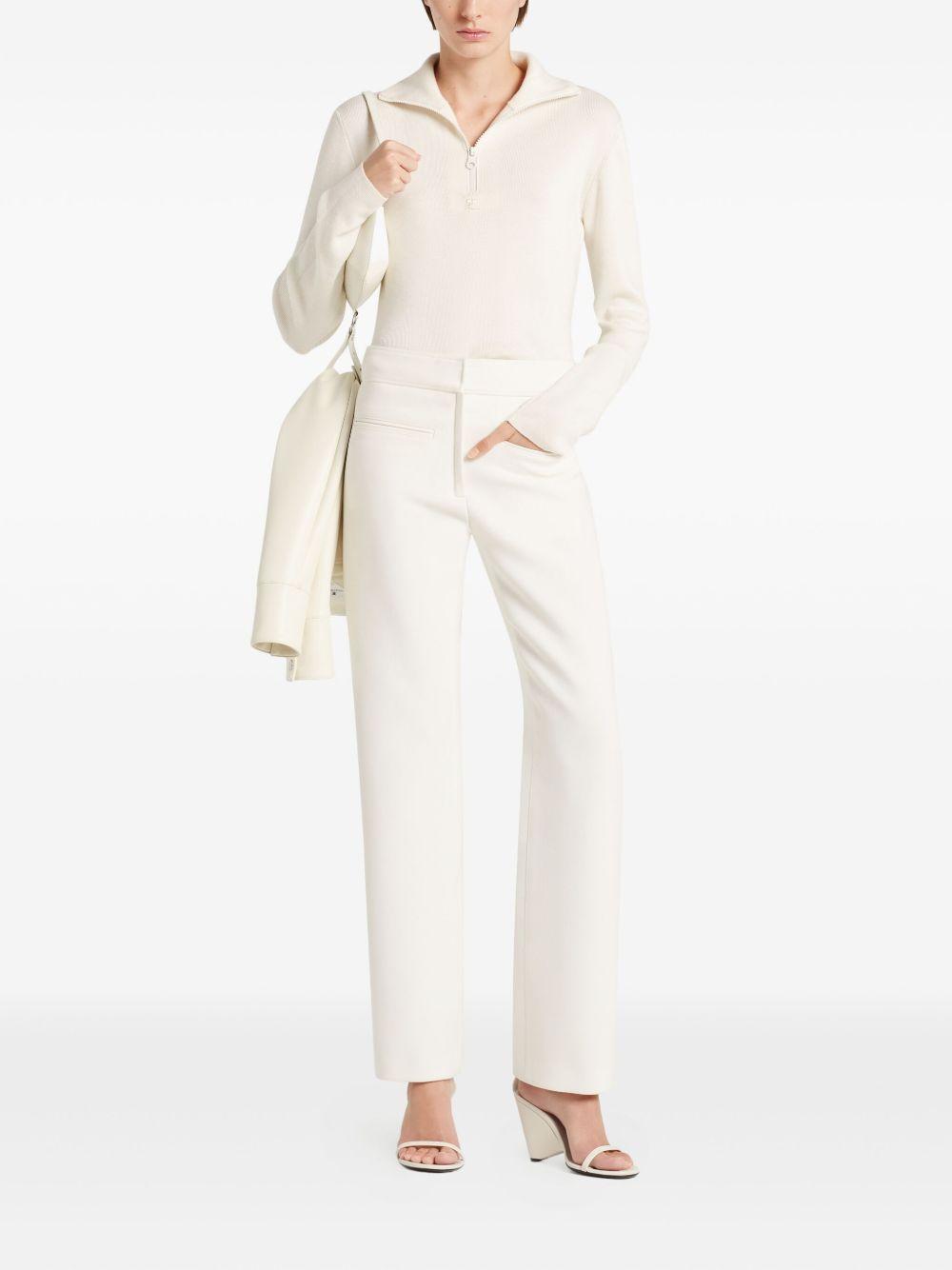 COURREGES Polo bianca con chiusura a zip sul collo 